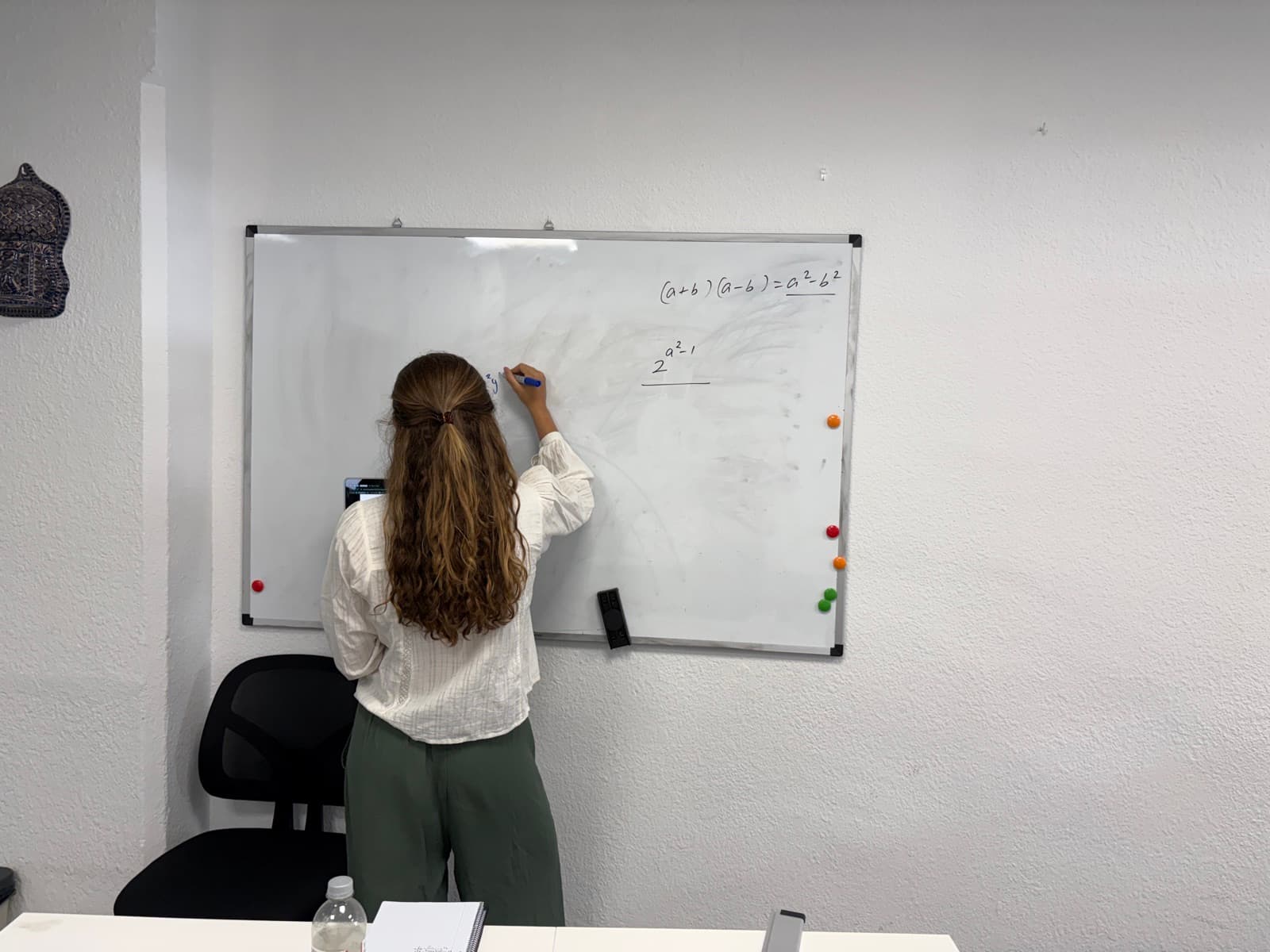 Student working through algebra at the whiteboard in our Sant Gervasi centre in Barcelona.